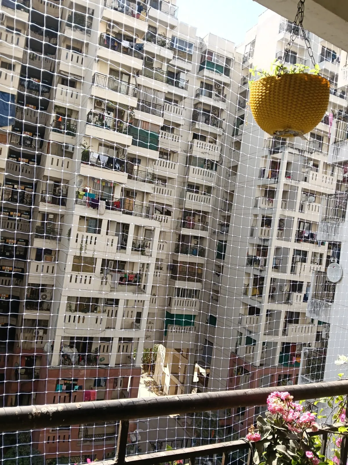Pigeon net installed on a high-rise apartment balcony